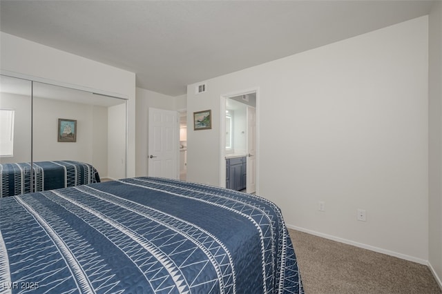 carpeted bedroom featuring baseboards, a closet, and visible vents