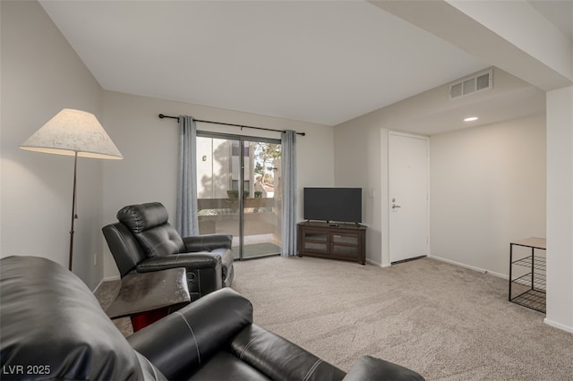 carpeted living room with baseboards, visible vents, and lofted ceiling