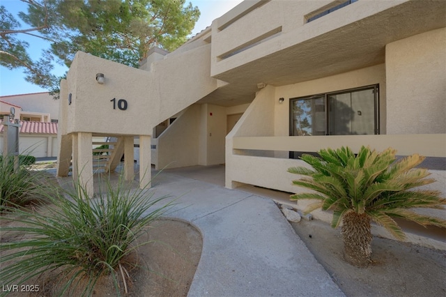 doorway to property featuring stucco siding