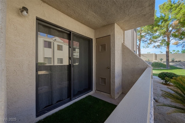 view of exterior entry featuring stucco siding