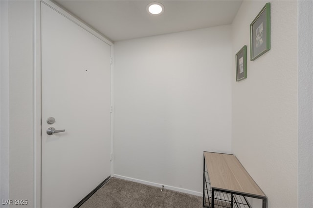 interior space with baseboards and carpet flooring