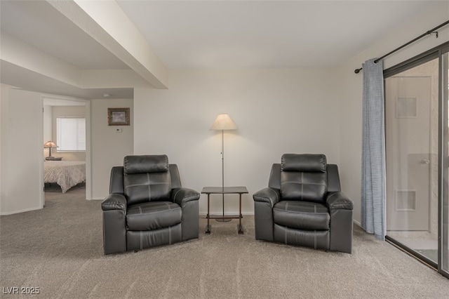sitting room featuring carpet floors, baseboards, and visible vents