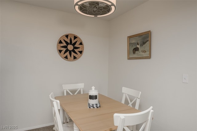carpeted dining area with baseboards