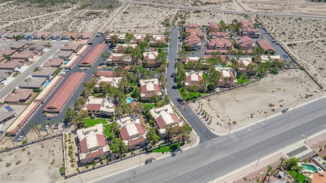 birds eye view of property with a residential view and view of desert