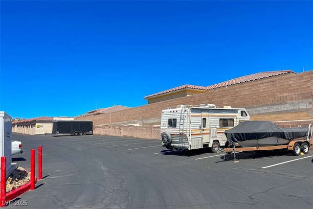 uncovered parking lot featuring fence