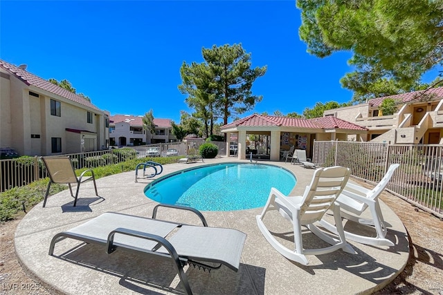 community pool with a gazebo, a patio area, fence, and a residential view