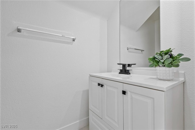 bathroom with vanity and baseboards