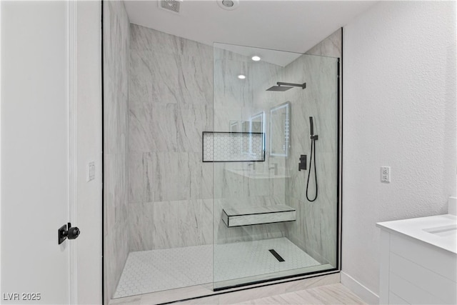 bathroom featuring recessed lighting, visible vents, a marble finish shower, and vanity