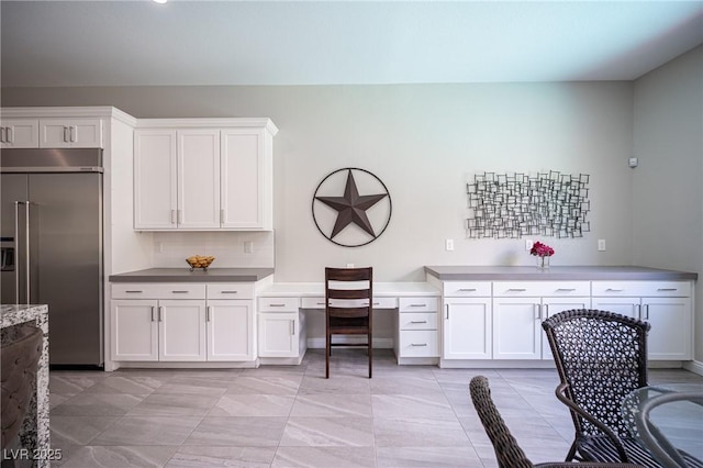 12018 Vento Forte Ave, Las Vegas, NV 89138 - kitchen featuring built in fridge, an office area, white cabinets, and tasteful backsplash