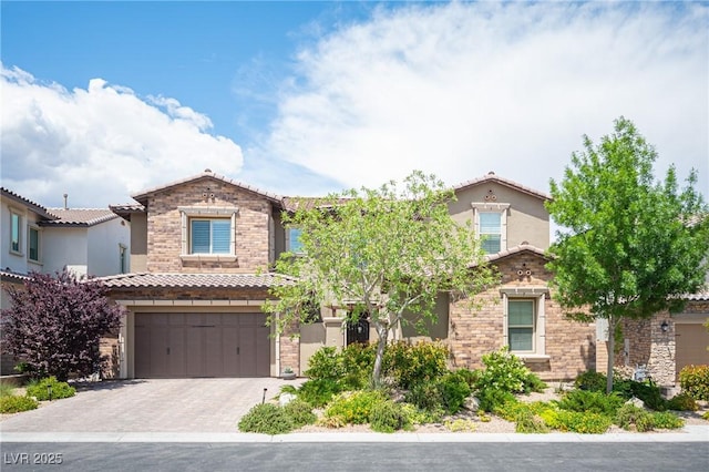 12018 Vento Forte Ave, Las Vegas, NV 89138 - mediterranean / spanish-style home with an attached garage, stone siding, stucco siding, driveway, and a tiled roof