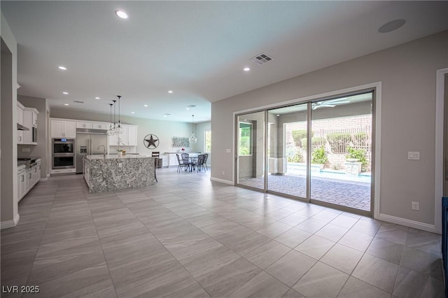 12018 Vento Forte Ave, Las Vegas, NV 89138 - living room featuring baseboards, recessed lighting, and light tile patterned floors