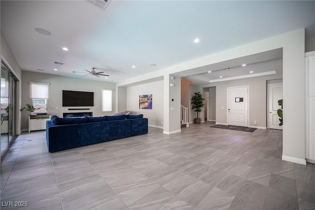 12018 Vento Forte Ave, Las Vegas, NV 89138 - living room featuring ceiling fan, plenty of natural light, a raised ceiling, recessed lighting, and baseboards