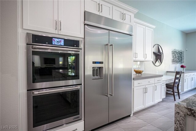 12018 Vento Forte Ave, Las Vegas, NV 89138 - kitchen featuring stainless steel appliances and white cabinetry