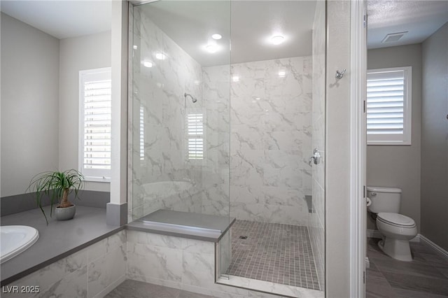 12018 Vento Forte Ave, Las Vegas, NV 89138 - bathroom featuring toilet, a marble finish shower, and baseboards