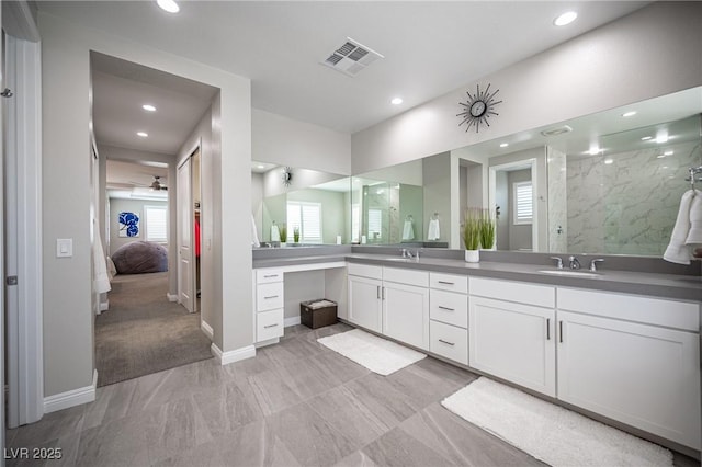 12018 Vento Forte Ave, Las Vegas, NV 89138 - ensuite bathroom with plenty of natural light, recessed lighting, double vanity, marble look tiles, and a shower