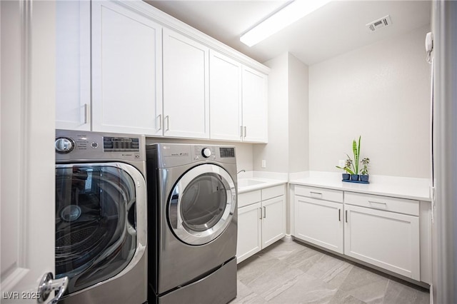 12018 Vento Forte Ave, Las Vegas, NV 89138 - clothes washing area featuring cabinet space and independent washer and dryer