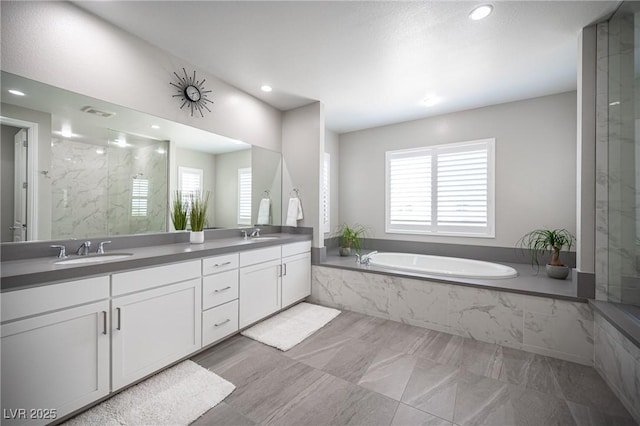 12018 Vento Forte Ave, Las Vegas, NV 89138 - bathroom featuring a bath, double vanity, recessed lighting, and a marble finish shower