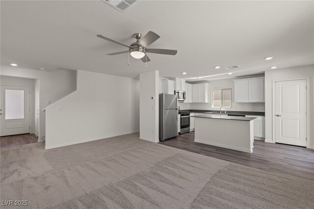 6234 Blood Lily Ave, Las Vegas, NV 89122 - kitchen featuring appliances with stainless steel finishes, white cabinetry, open floor plan, and visible vents