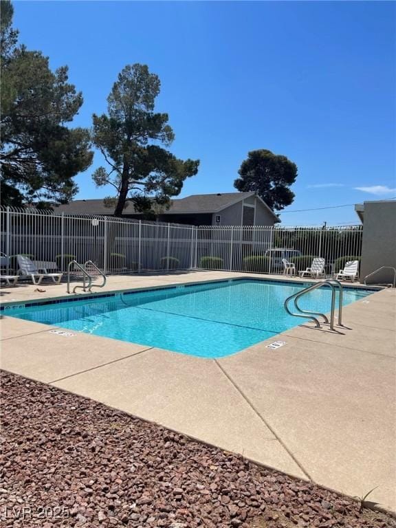 pool with fence and a patio area
