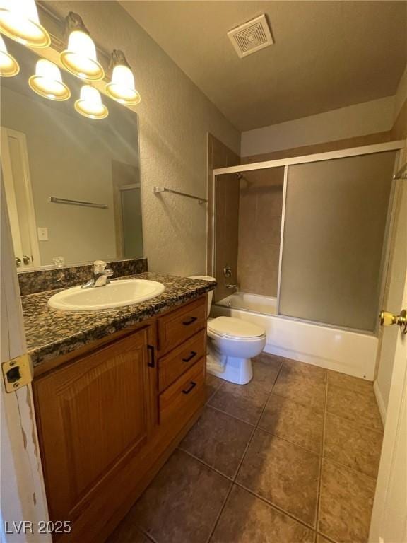 bathroom with vanity, toilet, tile patterned floors, visible vents, and bath / shower combo with glass door