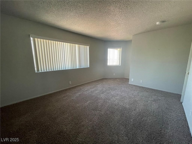 unfurnished room featuring baseboards, carpet flooring, and a textured ceiling