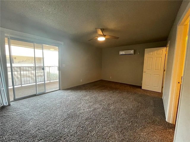 spare room with ceiling fan, a wall unit AC, carpet flooring, and a textured ceiling