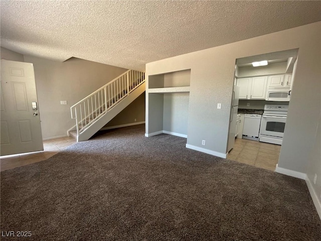 unfurnished living room with a textured ceiling, light tile patterned floors, baseboards, light carpet, and stairs
