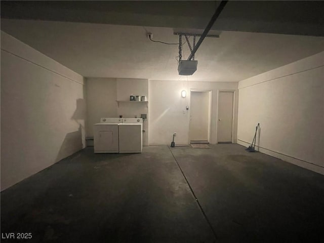 garage with washer and clothes dryer and a garage door opener
