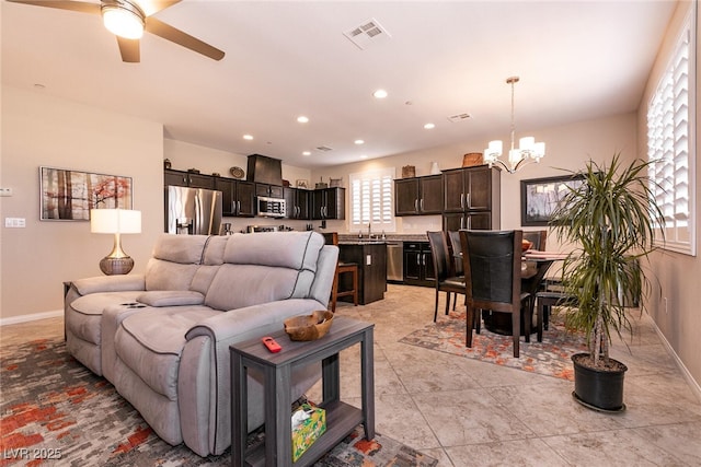 63 Via Di Mello, Henderson, NV 89011 - living room featuring a chandelier, ceiling fan, baseboards, and recessed lighting