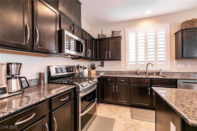 63 Via Di Mello, Henderson, NV 89011 - kitchen with appliances with stainless steel finishes, a sink, stone countertops, light tile patterned flooring, and recessed lighting