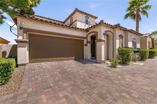 63 Via Di Mello, Henderson, NV 89011 - mediterranean / spanish home featuring stucco siding, decorative driveway, a garage, and a tile roof