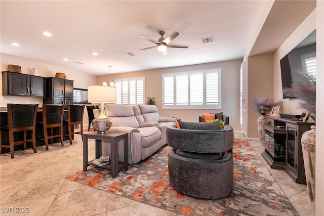 living room with recessed lighting, a ceiling fan, and visible vents