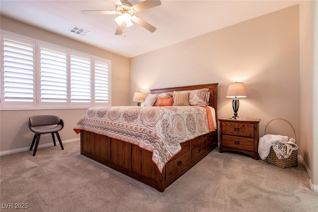 bedroom with visible vents, a ceiling fan, baseboards, and light colored carpet
