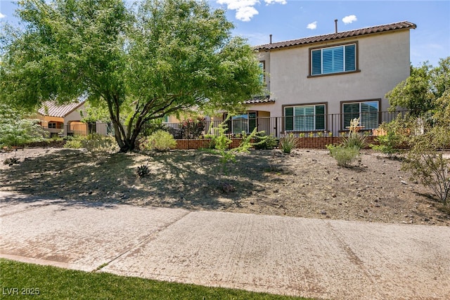 63 Via Di Mello, Henderson, NV 89011 - view of front of property featuring fence, a tile roof, and stucco siding