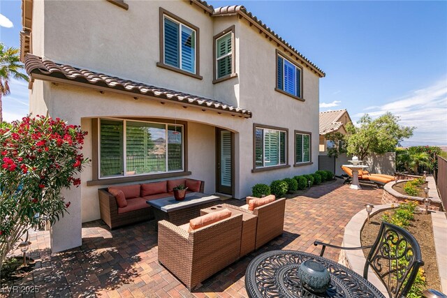 63 Via Di Mello, Henderson, NV 89011 - back of house featuring a patio, stucco siding, an outdoor living space, and a tile roof
