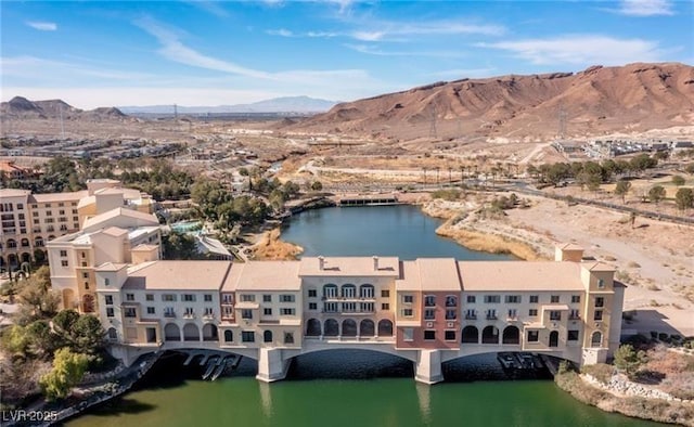 drone / aerial view featuring a water and mountain view