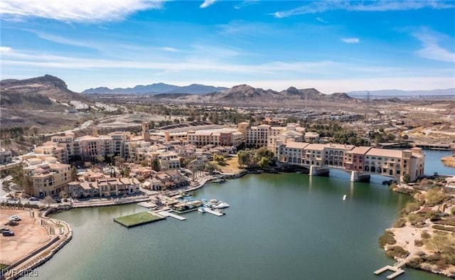 drone / aerial view featuring a water and mountain view