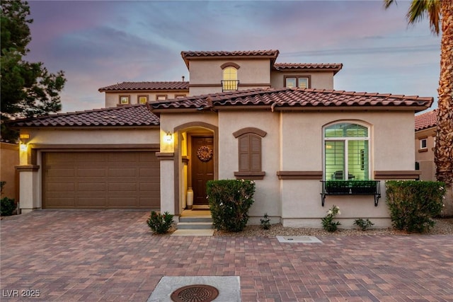 63 Via Di Mello, Henderson, NV 89011 - mediterranean / spanish house with a garage, stucco siding, decorative driveway, and a tile roof
