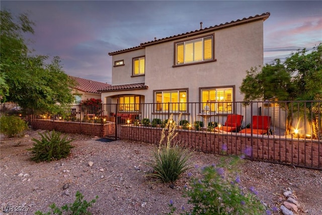 63 Via Di Mello, Henderson, NV 89011 - rear view of house featuring stucco siding, fence, and a tiled roof