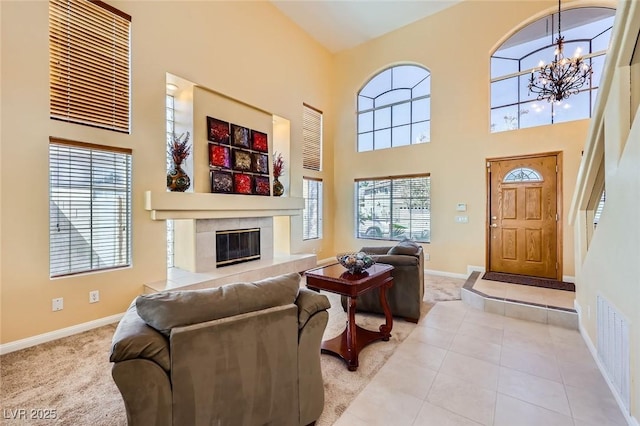 4 Bishopsgate Ter, Henderson, NV 89074 - living area featuring baseboards, a high ceiling, a chandelier, a high end fireplace, and light colored carpet