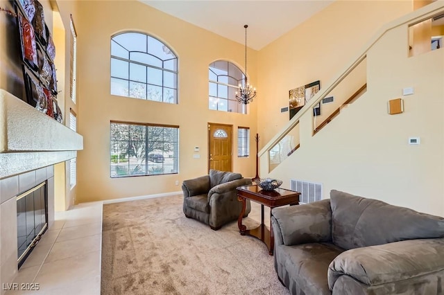 4 Bishopsgate Ter, Henderson, NV 89074 - tiled living area with stairs, a towering ceiling, carpet, a chandelier, and baseboards