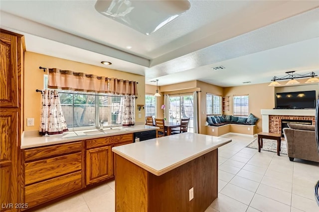 4 Bishopsgate Ter, Henderson, NV 89074 - kitchen with a sink, brown cabinetry, light countertops, light tile patterned flooring, and a kitchen island