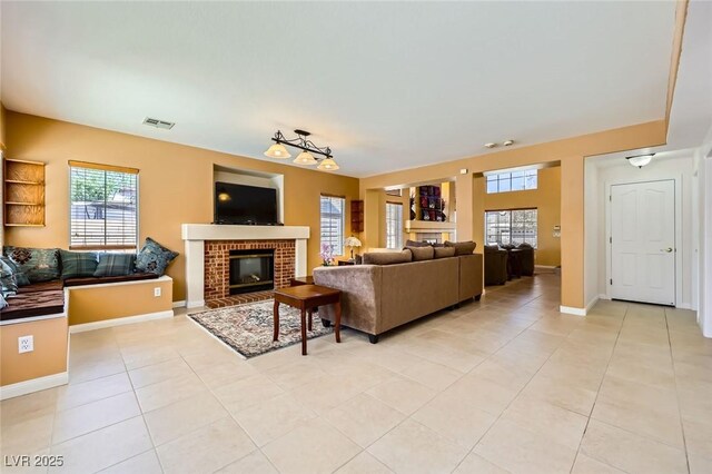 4 Bishopsgate Ter, Henderson, NV 89074 - living room with light tile patterned floors, a brick fireplace, and baseboards
