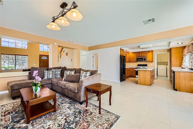 4 Bishopsgate Ter, Henderson, NV 89074 - living area with washer / dryer, baseboards, and light tile patterned flooring