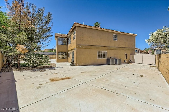 4 Bishopsgate Ter, Henderson, NV 89074 - rear view of house with a fenced backyard, a patio area, central AC unit, and stucco siding