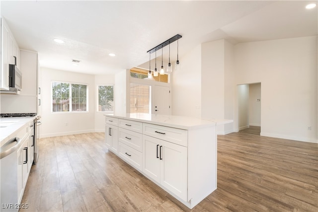 2505 Showcase Dr, Las Vegas, NV 89134 - kitchen featuring light wood-type flooring, stainless steel appliances, recessed lighting, and white cabinets