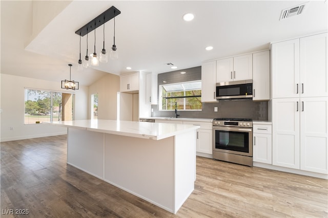 2505 Showcase Dr, Las Vegas, NV 89134 - kitchen with stainless steel appliances, light wood finished floors, healthy amount of natural light, and recessed lighting