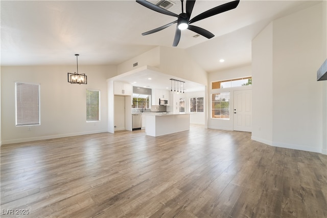 2505 Showcase Dr, Las Vegas, NV 89134 - unfurnished living room featuring a chandelier, lofted ceiling, a ceiling fan, light wood-type flooring, and baseboards