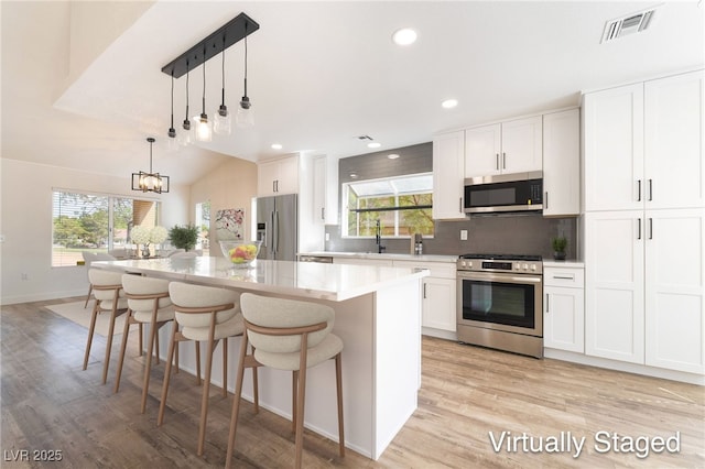 2505 Showcase Dr, Las Vegas, NV 89134 - kitchen with stainless steel appliances, plenty of natural light, light wood finished floors, tasteful backsplash, and recessed lighting