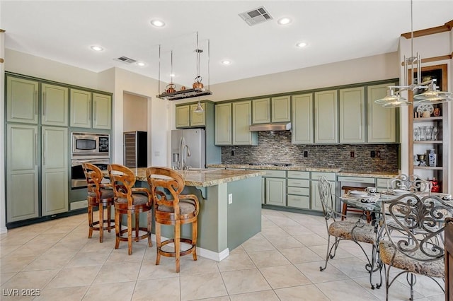 kitchen featuring green cabinets, stainless steel appliances, and visible vents